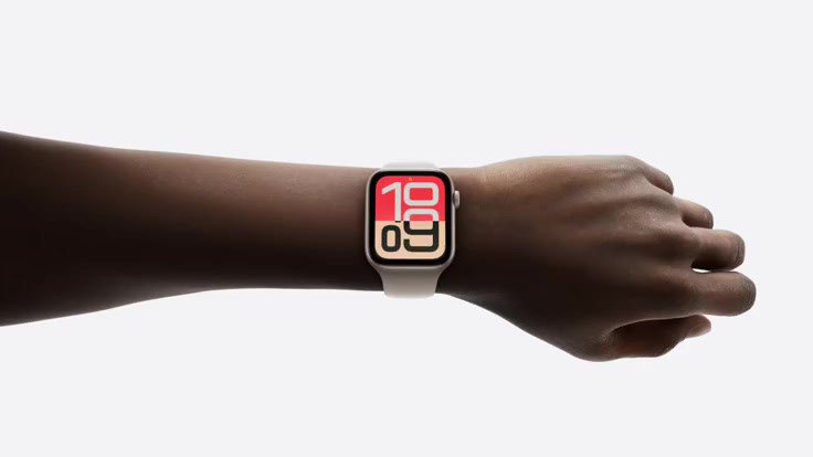 The watch worn on a wrist against a light studio backdrop